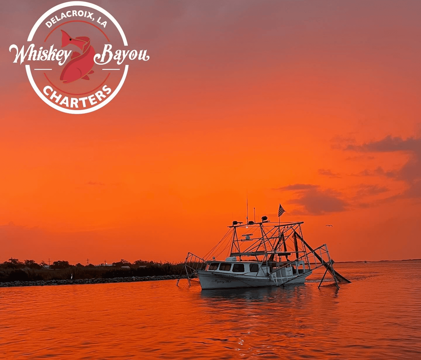 A fishing boat on the calm waters of Delacroix, Louisiana, at sunset, with the sky glowing in deep orange hues.